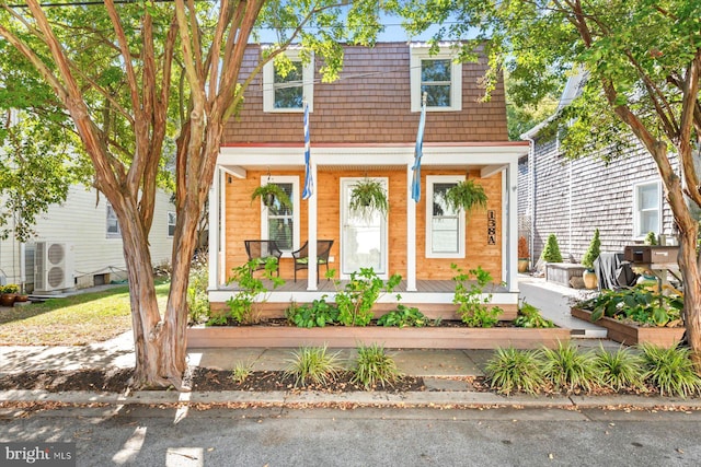 view of front of house with ac unit and covered porch