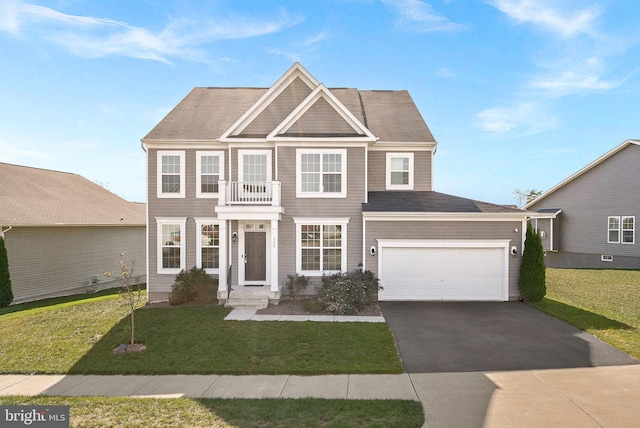 view of front of home with a balcony, a front lawn, and a garage