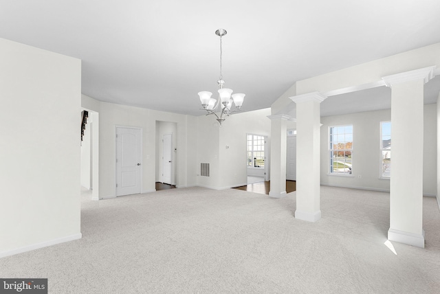 interior space with ornate columns and an inviting chandelier