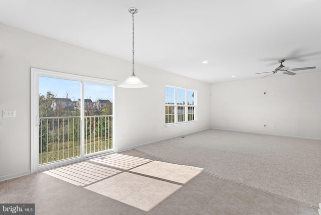 interior space featuring a wealth of natural light, light colored carpet, and ceiling fan