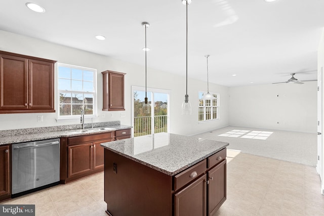 kitchen featuring sink, a center island, dishwasher, and plenty of natural light