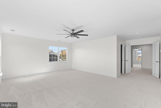 carpeted spare room featuring ceiling fan