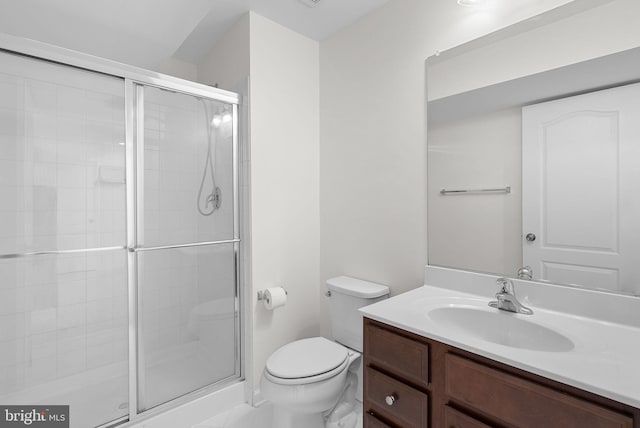 bathroom with toilet, walk in shower, and vanity