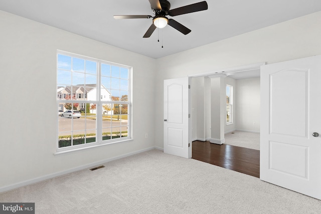 unfurnished room featuring hardwood / wood-style floors and ceiling fan