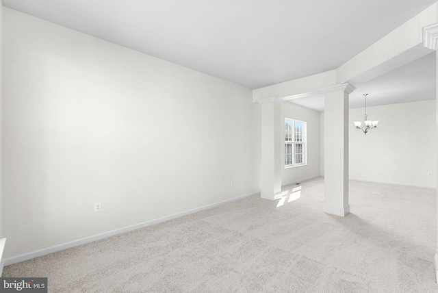 empty room featuring light carpet and a notable chandelier