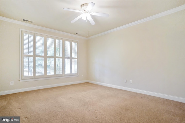 empty room featuring ornamental molding, ceiling fan, and light colored carpet