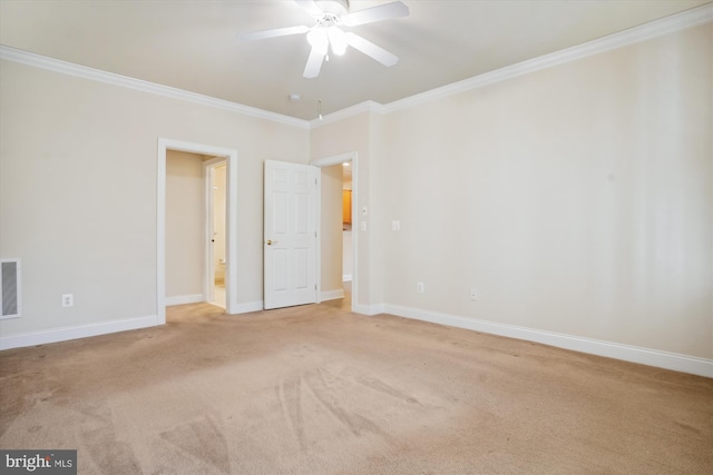 carpeted empty room with ceiling fan and crown molding