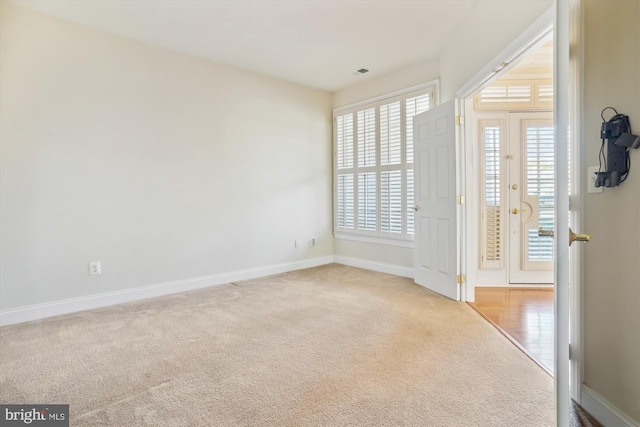 carpeted empty room with a wealth of natural light