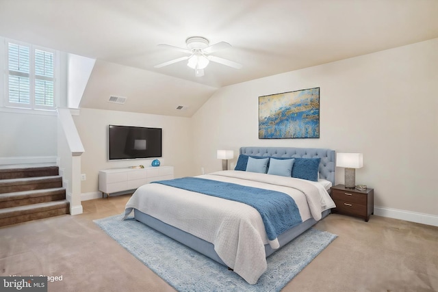 carpeted bedroom with vaulted ceiling and ceiling fan