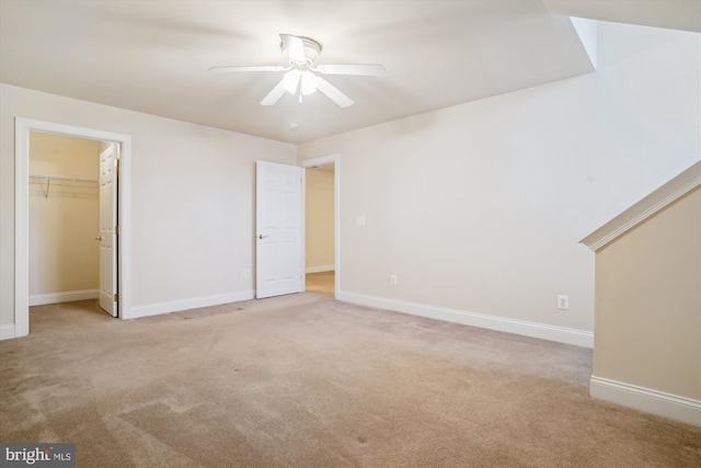 interior space featuring light carpet and ceiling fan