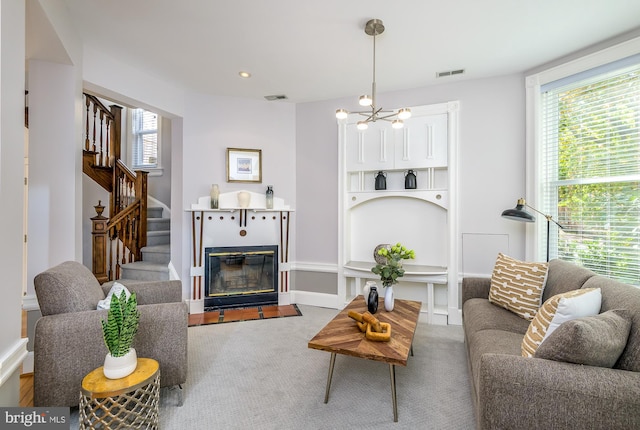 living room featuring carpet floors and a chandelier