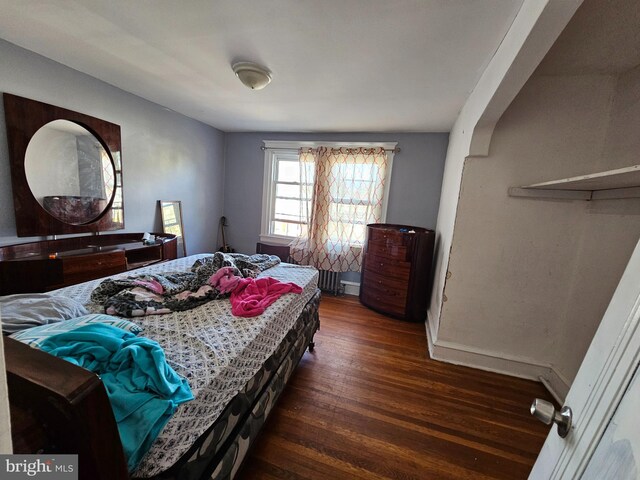 bedroom featuring dark hardwood / wood-style flooring