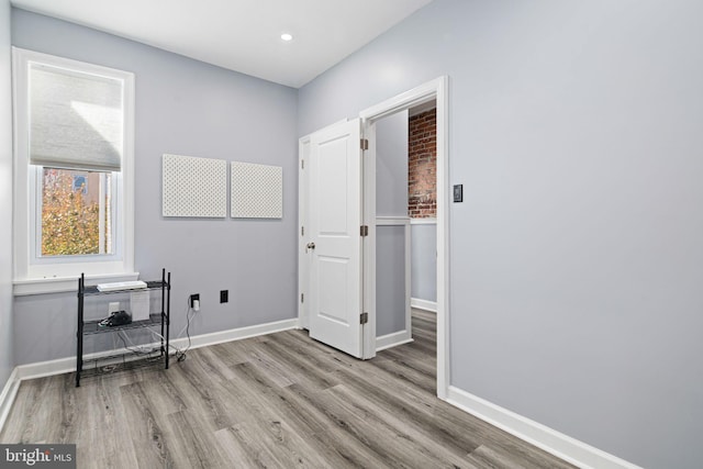 interior space with baseboards, recessed lighting, and wood finished floors
