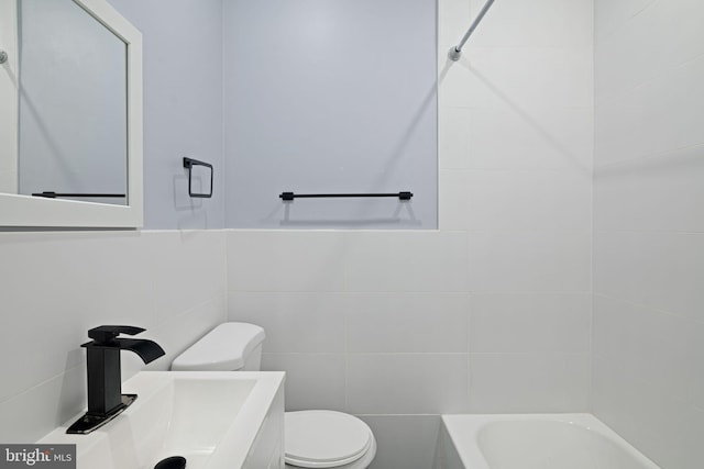 full bath featuring vanity, toilet, and tile walls