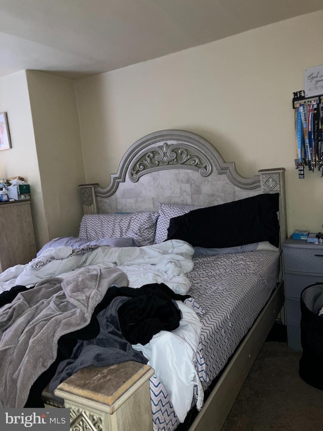 bedroom featuring dark carpet