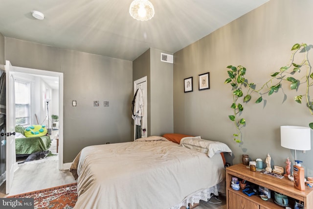 bedroom with hardwood / wood-style flooring