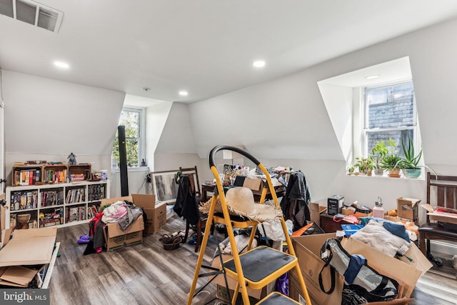 misc room with light hardwood / wood-style floors and lofted ceiling