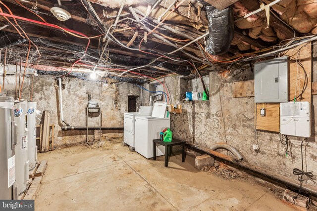 basement featuring electric water heater, electric panel, and independent washer and dryer