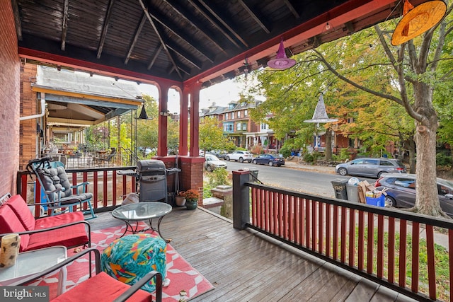 wooden deck with a grill