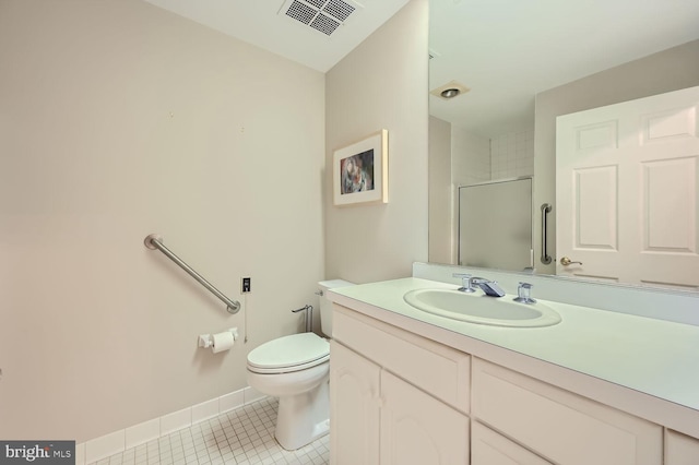 bathroom featuring tile patterned floors, vanity, walk in shower, and toilet