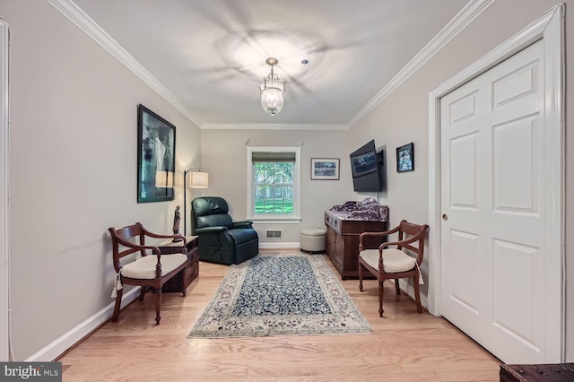 living area featuring light wood-type flooring and ornamental molding