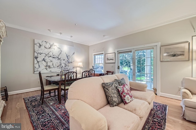 living room with light hardwood / wood-style flooring and ornamental molding