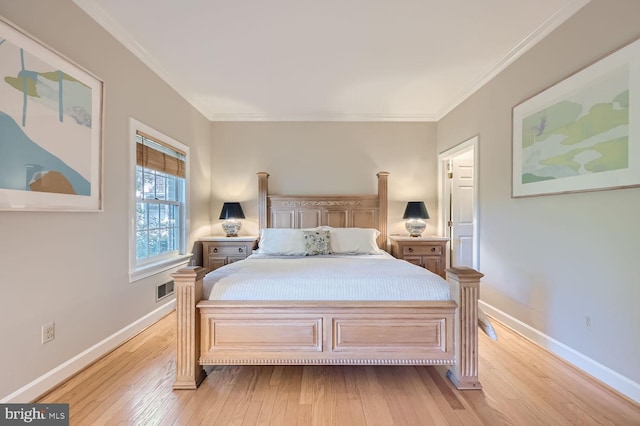 bedroom featuring light wood-type flooring and crown molding