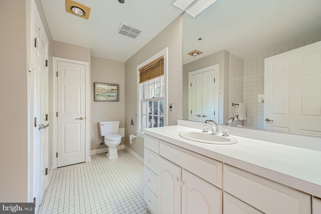 bathroom with vanity, toilet, and tile patterned floors