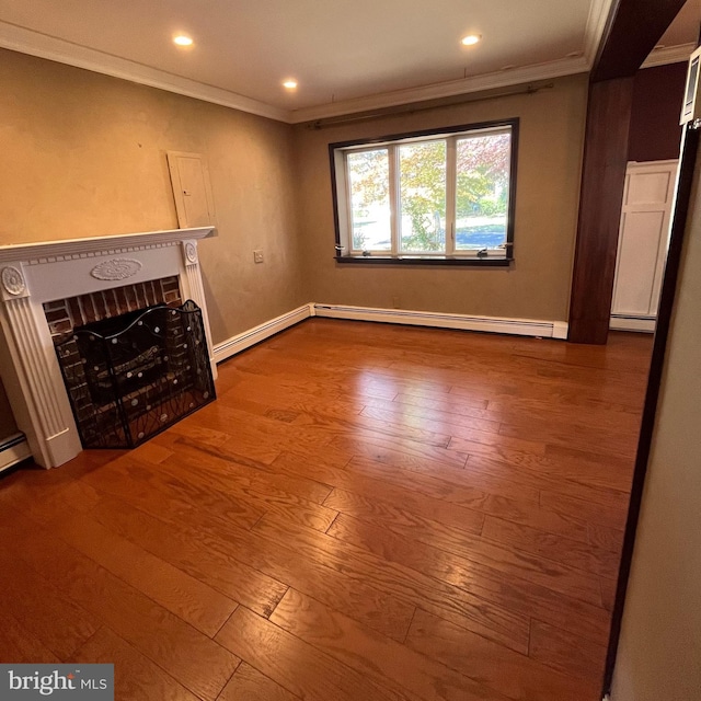 unfurnished living room featuring crown molding, wood-type flooring, and a baseboard heating unit