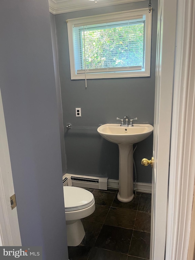 bathroom with a healthy amount of sunlight, crown molding, a baseboard heating unit, and toilet