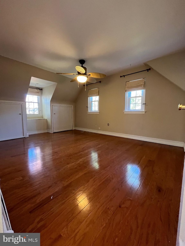 bonus room with dark hardwood / wood-style floors, ceiling fan, vaulted ceiling, and a wealth of natural light