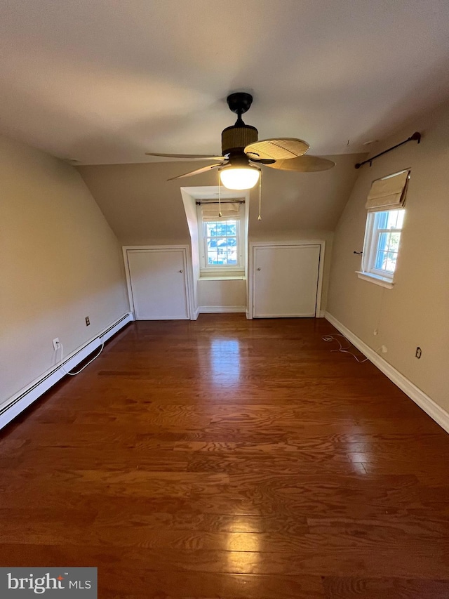 bonus room featuring ceiling fan, vaulted ceiling, plenty of natural light, and dark hardwood / wood-style floors