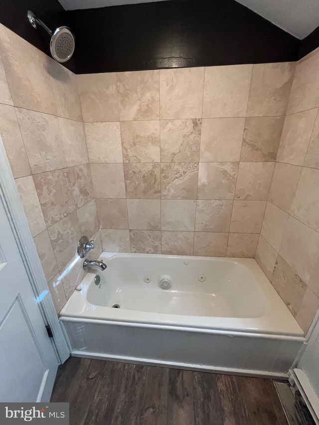 bathroom featuring bathtub / shower combination and hardwood / wood-style floors