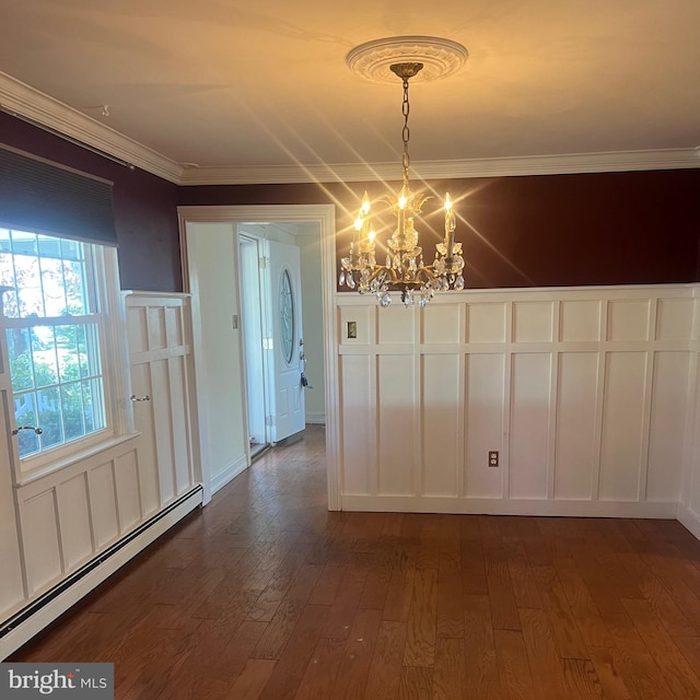 unfurnished dining area with ornamental molding, a baseboard heating unit, a chandelier, and dark hardwood / wood-style floors