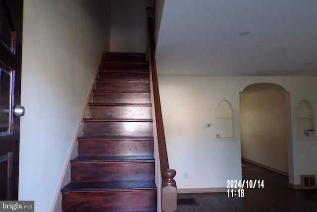 stairway featuring hardwood / wood-style floors