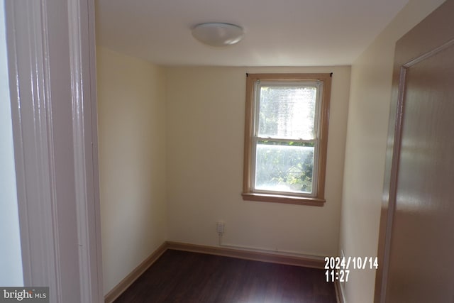 spare room with dark hardwood / wood-style flooring