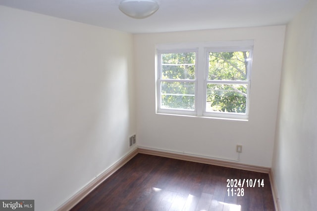 spare room with dark hardwood / wood-style flooring