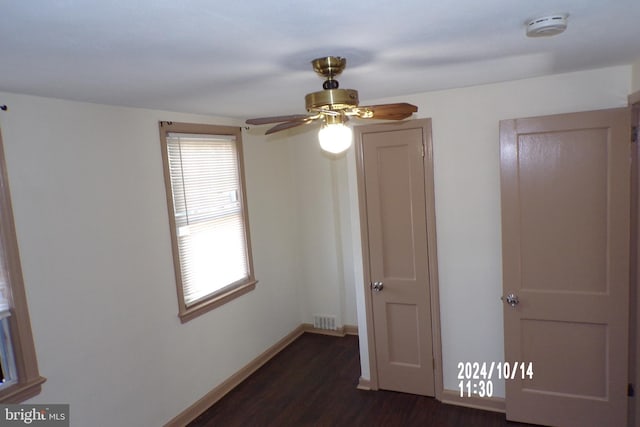 unfurnished bedroom with dark hardwood / wood-style floors and ceiling fan