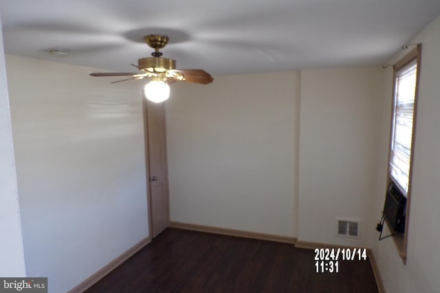 empty room with dark hardwood / wood-style floors and ceiling fan