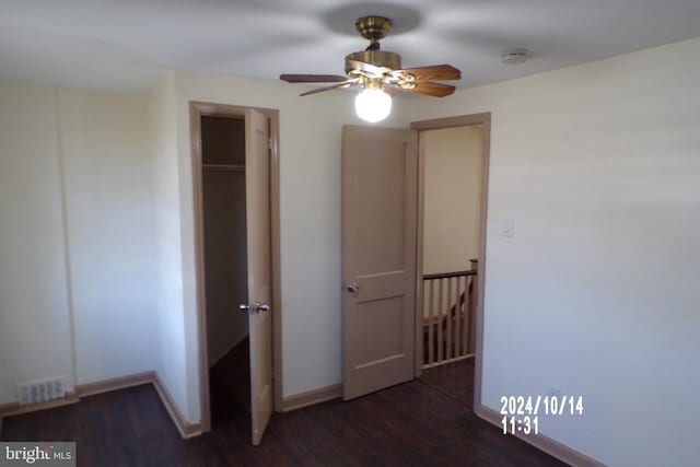 unfurnished bedroom featuring a closet, ceiling fan, and dark wood-type flooring