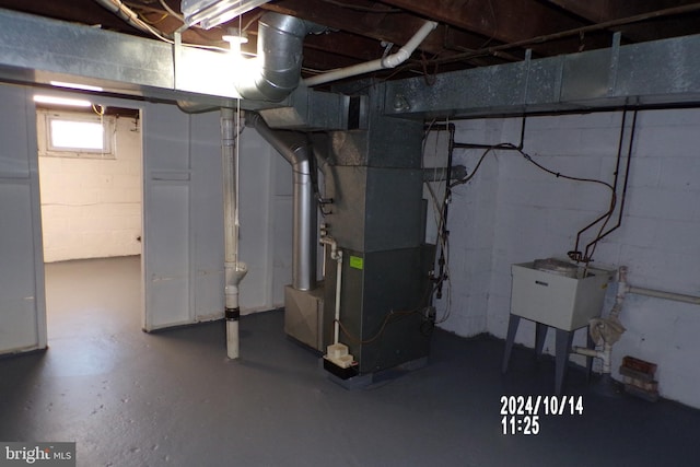 basement with heating unit and sink