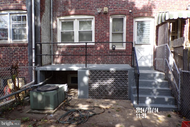 doorway to property featuring central air condition unit