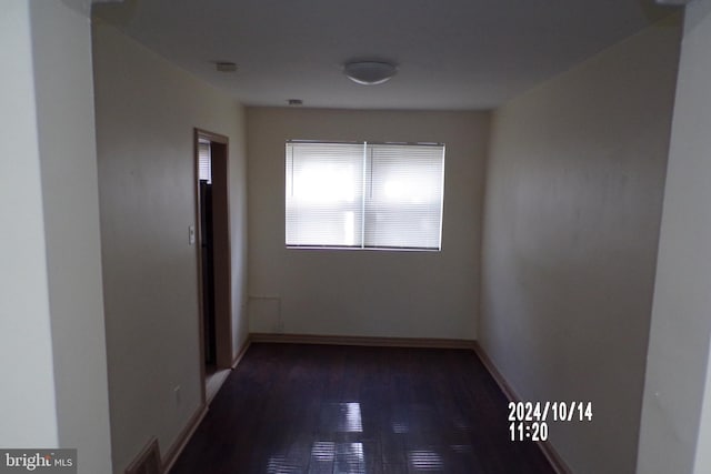 hallway with dark hardwood / wood-style flooring