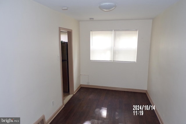 empty room with dark hardwood / wood-style floors