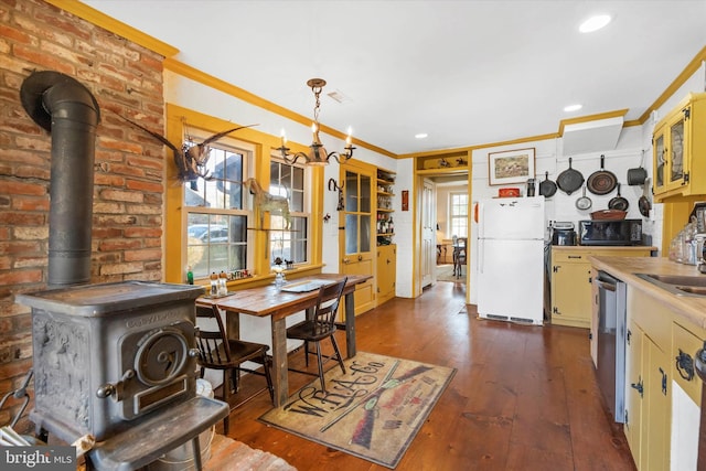 interior space with ornamental molding, a chandelier, and dark hardwood / wood-style flooring