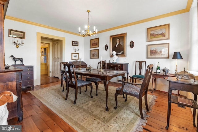 dining space with crown molding, a notable chandelier, and dark wood-type flooring