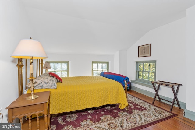 bedroom featuring vaulted ceiling and hardwood / wood-style floors