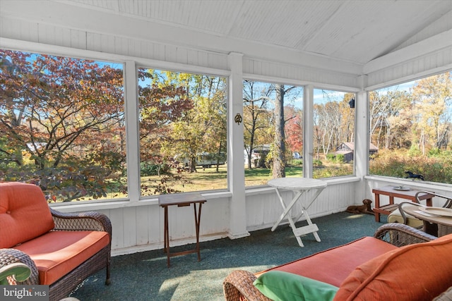 sunroom / solarium featuring vaulted ceiling