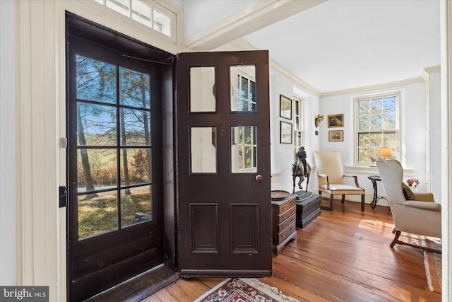 entrance foyer with wood-type flooring and ornamental molding