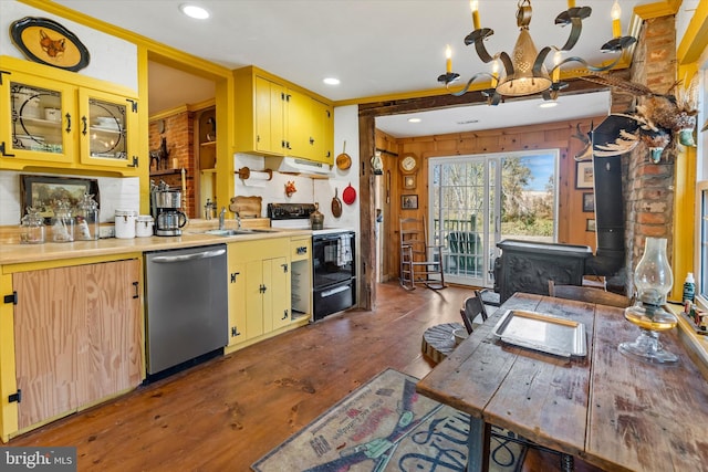 kitchen with a wood stove, dark hardwood / wood-style flooring, stainless steel dishwasher, a notable chandelier, and white electric range oven